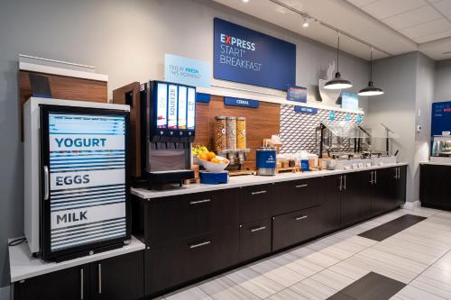 a cashier counter in a restaurant with a cash register at Holiday Inn Express & Suites - Edmonton SW – Windermere by IHG in Edmonton