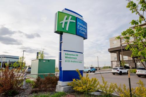 a sign in a parking lot with a building at Holiday Inn Express & Suites - Edmonton SW – Windermere by IHG in Edmonton