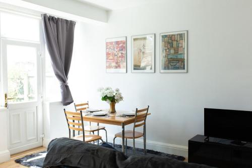 a living room with a table and chairs and a tv at An entire 3 Bedroom house in Beeston United Kingdom in Beeston