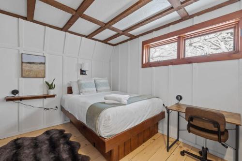 a bedroom with a bed and a desk and a window at Maple Pine w Hot Tub Pool Table 3min to Mount Snow in Dover