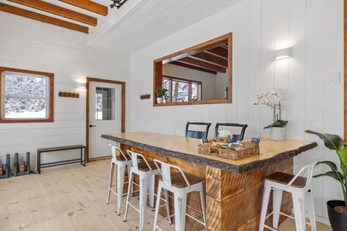 a large kitchen with a large wooden counter and stools at Maple Pine w Hot Tub Pool Table 3min to Mount Snow in Dover