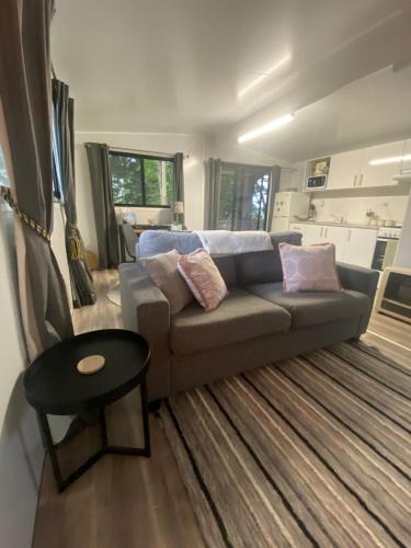 a living room with a couch and a table at Mountain Escape in Wentworth Falls