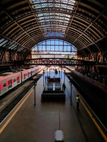 a large train station with two trains in it at GREEN ONE - Apto novo, moderno, varanda, poucos passos da estação Luz in Sao Paulo