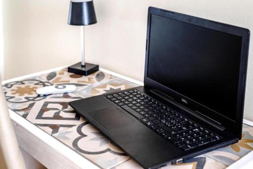 a laptop computer sitting on top of a table at GIOSAHOUSE in Uggiano la Chiesa