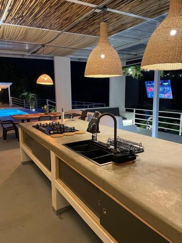 a kitchen with a sink and a counter top at Colina Shalom nature & comfort in Nocaima