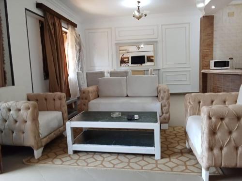 ein Wohnzimmer mit einer Couch und einem Couchtisch in der Unterkunft chalet 1 villa150 4 bedrooms ground floor green beach in El-Alamein