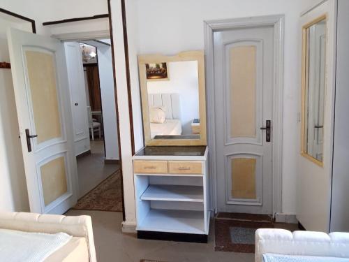 ein Ankleidezimmer mit einem Spiegel und einem weißen Schrank in der Unterkunft chalet 1 villa150 4 bedrooms ground floor green beach in El-Alamein