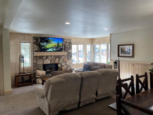 a living room with a couch and a fireplace at Mountainback #57, Den in Mammoth Lakes