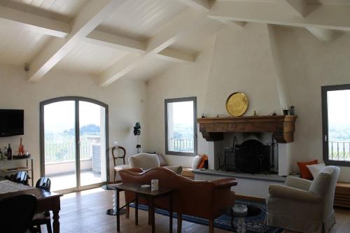 a living room with a fireplace and windows at Relais Pugliano in Monterappoli