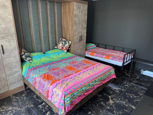 a bedroom with two twin beds in a room at Belek Room Voyage in Belek
