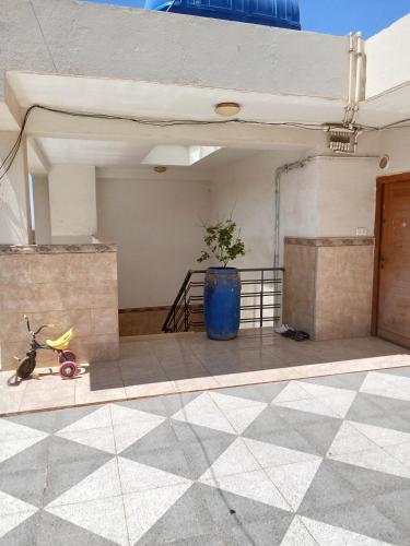 a blue vase sitting on the floor of a building at Cléopâtre épouse de Juba ll in Tefeschoun