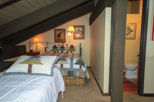 a bedroom with a large bed and a bathroom at Discovery 4 142 Loft in Mammoth Lakes