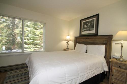 Un dormitorio con una cama blanca grande y una ventana en Discovery 4 #117, en Mammoth Lakes