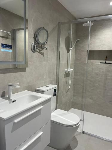 a bathroom with a shower and a toilet and a sink at Alondras Luxury Paradise fully renovated in Arona