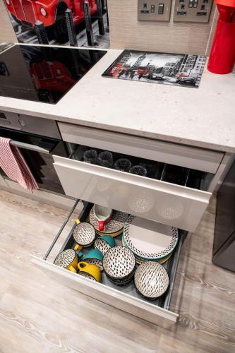 a drawer in a counter with cupcakes in it at ApArt Gallery Apartment 2, Stylish 3- Bed , Free Parking ,Sleeps 6 in Bedford