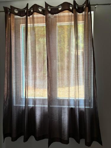 a window with black curtains in a room at Deaf Valley Apartment 2 in Reljići