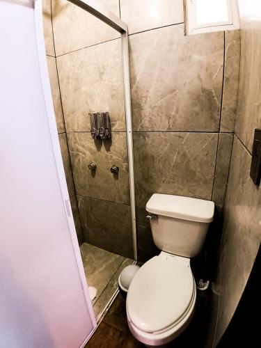 a small bathroom with a toilet and a shower at Rose Room, Paseo Durango in Durango
