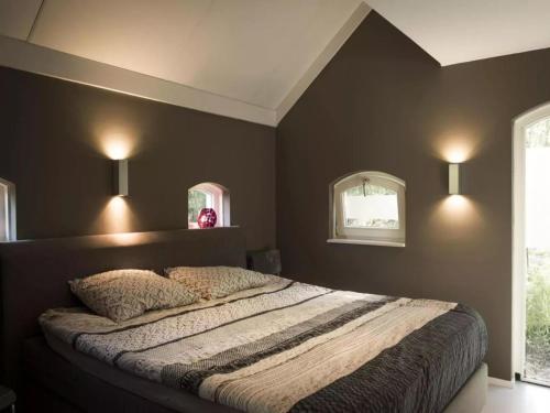 a bedroom with a bed with two pillows on it at Design Lodge Twente in Buurse