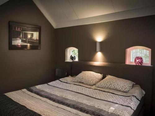 a bedroom with a bed with two pillows on it at Design Lodge Twente in Buurse