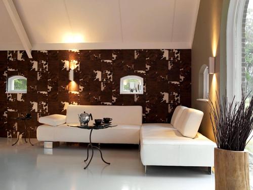 a living room with a white couch and a table at Design Lodge Twente in Buurse