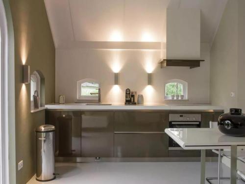 a kitchen with stainless steel appliances and a table at Design Lodge Twente in Buurse