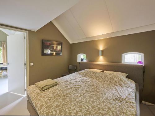 a bedroom with a bed in a room at Design Lodge Twente in Buurse