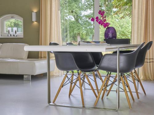 a dining room with a table and four chairs at Design Lodge Twente in Buurse
