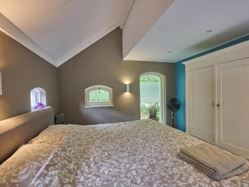 a bedroom with a large bed and a window at Design Lodge Twente in Buurse