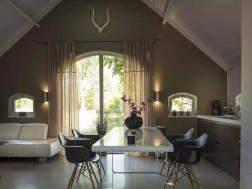 a living room with a table and chairs at Design Lodge Twente in Buurse