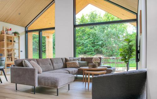 a living room with a couch and a table at Cozy Home In Glesborg With Sauna in Glesborg