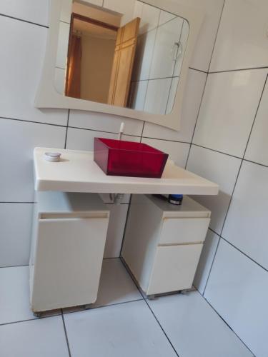 a bathroom with a white sink and a mirror at Casa aconchegante in São Raimundo Nonato