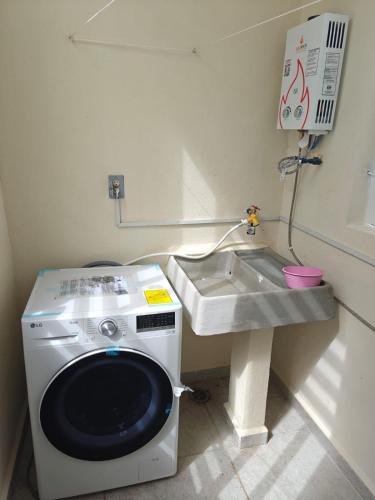 a washing machine in a bathroom with a sink at Casa Maya comfortable apartment in Tulum in Tulum