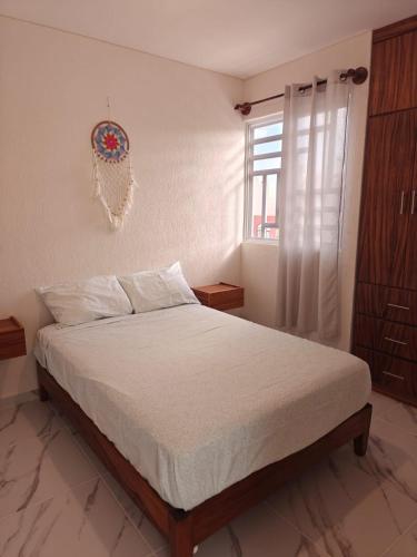 a bedroom with a bed and a window at Casa Maya comfortable apartment in Tulum in Tulum