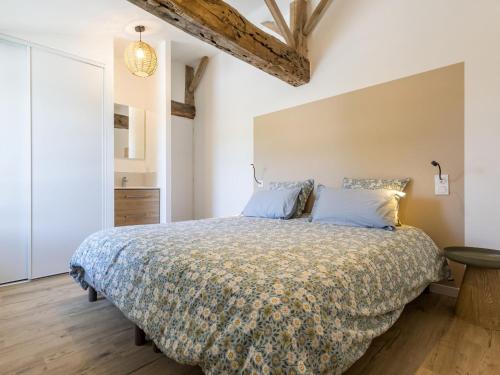 Un dormitorio con una cama grande con almohadas azules. en Gîte rénové proche plages, parking, jardin privatif, terrasse sud-est - FR-1-306-1315, en Machecoul