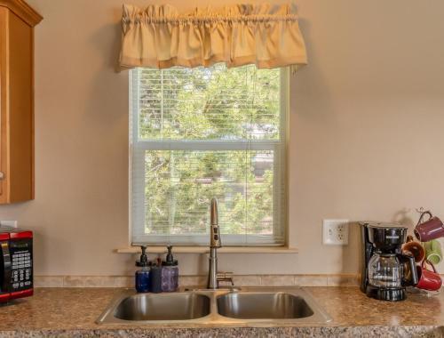 a kitchen sink in front of a window at Baby Bear Cabin in West Yellowstone