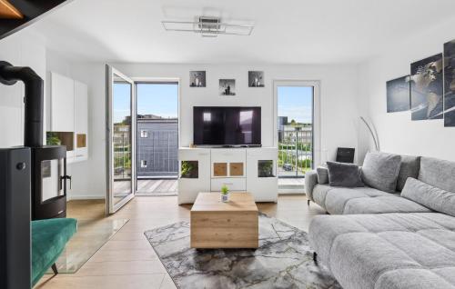 a living room with a couch and a tv at 5 Residenz Panoramablick in Winterberg
