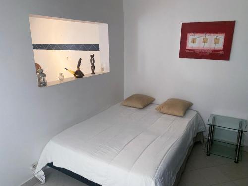 a bedroom with a white bed in a room at Touty in Dakan