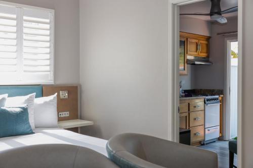a bedroom with a bed and a bath tub at Marina Beach Motel in Santa Barbara