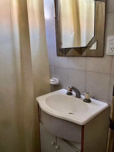 a bathroom with a sink and a mirror at Casa familiar cómoda in Santiago del Estero