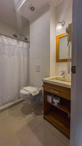 a bathroom with a toilet and a sink at Majestic City Suites & Beach Hotel in Willemstad