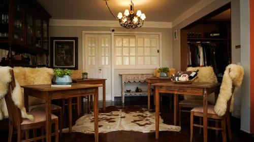 a kitchen with two tables and chairs and a fireplace at Secreto Boutique Hotel in Campos do Jordão