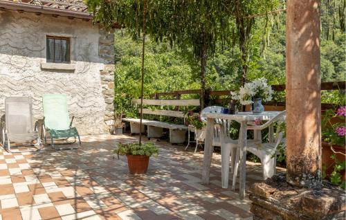 a patio with a table and a bench at Awesome Apartment In Castelfranco Piandiscò in Castelfranco Piandisco