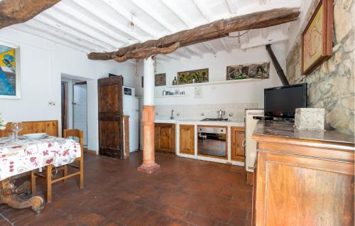 a kitchen with a table and a television and a counter at Awesome Apartment In Castelfranco Piandiscò in Castelfranco Piandisco