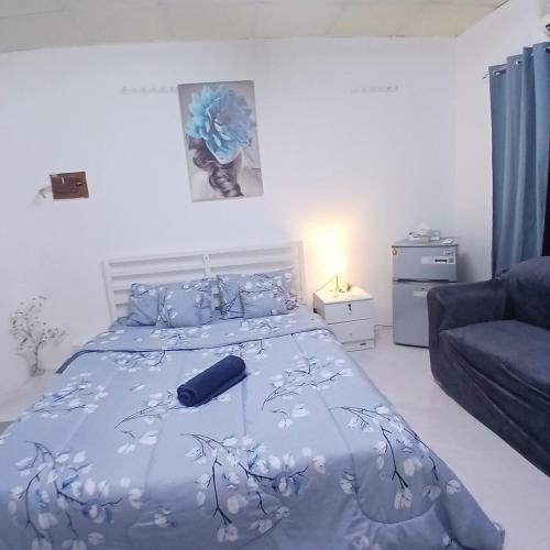 a bedroom with a bed with a blue comforter at Al Ain Blue in Al Ain
