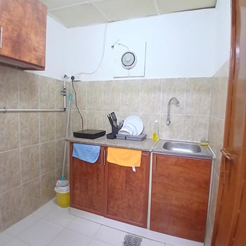 a kitchen with a sink and a counter top at Al Ain Blue in Al Ain
