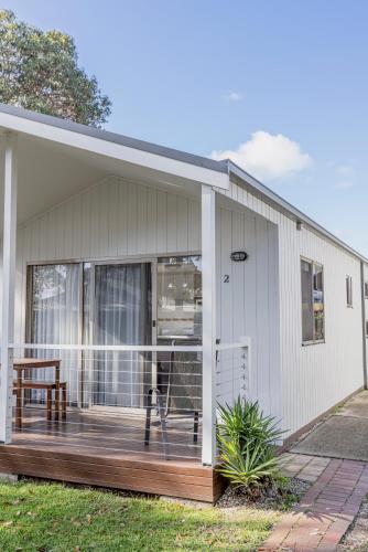 a house with a porch with a deck at Ocean Grove Holiday Park in Ocean Grove