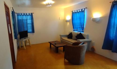 a living room with a couch and a table at The Dive Hut - Boutique Apartments in Kralendijk