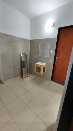 a bathroom with a sink and a small refrigerator at Lavalle in Santiago del Estero