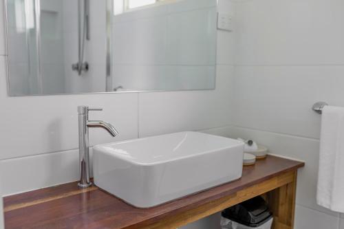 a bathroom with a white sink and a mirror at Ocean Grove Holiday Park in Ocean Grove
