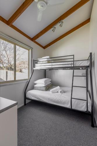 a bedroom with a bunk bed in a room at Ocean Grove Holiday Park in Ocean Grove